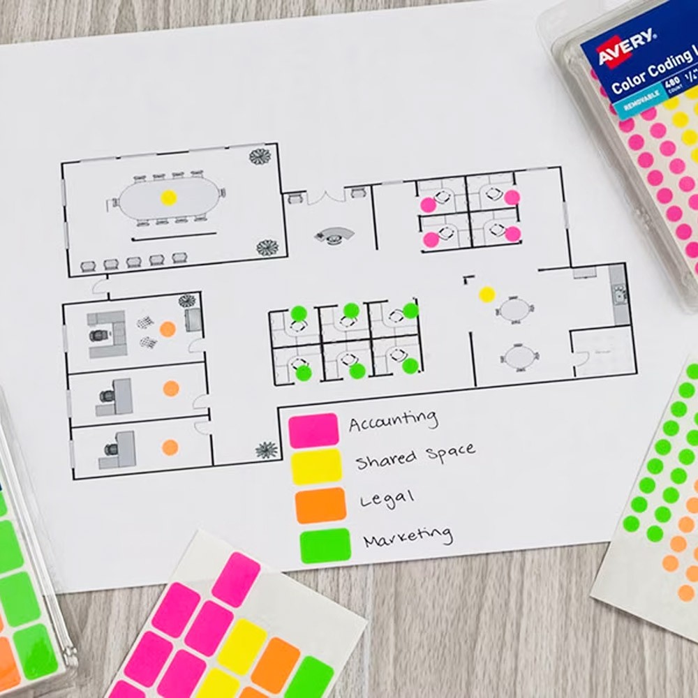 Color coding stickers being used on a office space map.